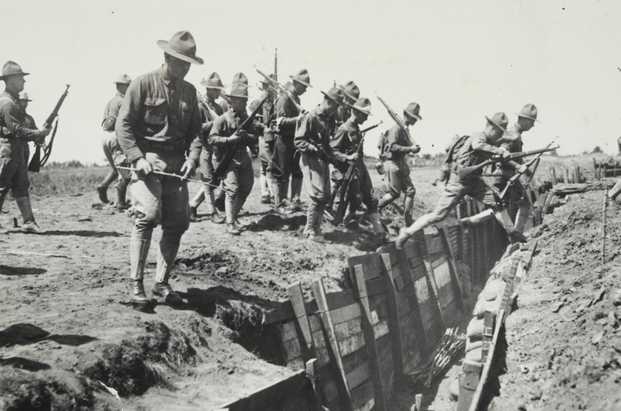 Black and white photograph of candidates jumping over an entrenchment at the Officers’ Training Camp, Fort Snelling, 1917. 