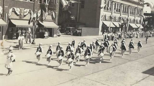 Black and white photograph of the American Legion drum and bugle corps on parade at state competition in Albert Lea, Minnesota, August, 1935.