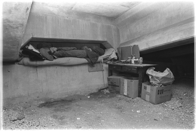 Two people without housing sleeping under an I-94 overpass