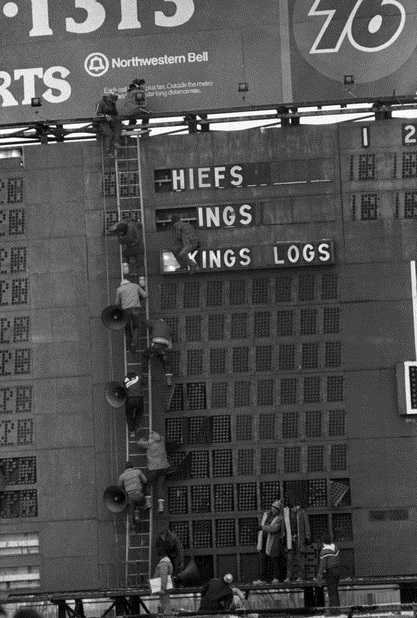 Viking fans strip the scoreboard after the Vikings lose to Kansas