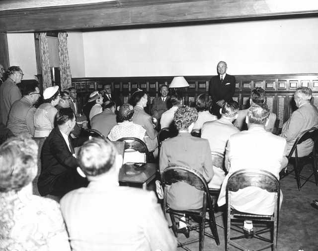 Black and white photograph of former president Harry Truman speaks to guests in Nelson Hall, the post’s headquarters, in July 1953