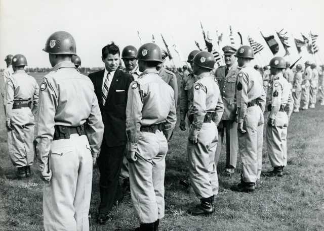 Black and white photograph of Governor Orville Freeman inspecting his troops at Camp Ripley, 1955.