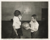 Black and white photograph of two girls playing basketball at Phyllis Wheatley House, ca. 1925.