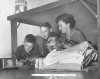 Black and white photograph of a family civil defense drill, 1953.