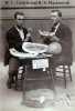 Black and white photograph of W. L. Carlyle and R. S. Mackintosh eating watermelon that was awarded first premium probably at the Minnesota State Fair, 1895. 