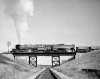 Black and white photograph of a Duluth, Missabe and Iron Range train on railroad bridge west of Two Harbors, ca. 1940.