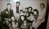 Black and white photograph of Hilda Simms surrounded by her mother, several of her siblings, and nephews, c.1955.