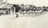 Black and white photograph of the American Legion Auxiliary drum and bugle corps on parade in Bagley, Minnesota, 1935.