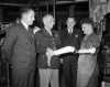 Black and white photograph of Major General Norman Kirk, Surgeon General of the Army, inspecting Minnesota-made artificial limbs, December 6, 1943.