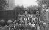 Black and white photograph of workers posed by Pillsbury “A” Mill in Minneapolis, ca. 1918. 