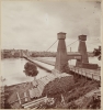 Black and white photograph of the Hennepin Bridge from Nicollet Island, c.1868.