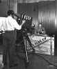 Black and white photograph of a KSTP-TV cameraman filming the This Side Up program, 1950.