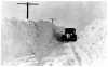 Car driving through a snowbank