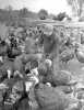 Black and white photograph of a man feeding turkeys, ca. 1930. Photograph by Minneapolis Journal.