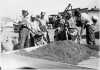 Black and white photograph of WPA crew mixing grasshopper bait for distribution to farmers, State Highway Maintenance Shops at Hopkins, 1937. 