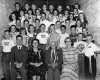 Black and white photograph of Edward F. Waite posed with students at Waite Park School, c.1955.