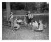 Knutson playing her accordion for a group of children in a park