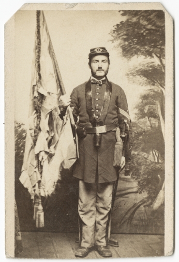 Color-bearer holding tattered First Minnesota flag after Gettysburg