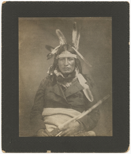 Black and white photograph of the Ho-Chunk leader Baptiste Lasallier wearing a mix of American Indian and Euro-American clothing, c.1855.