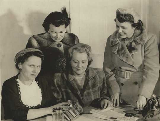 Black and white photograph of four Crookston BPW members collecting coins for the annual March of Dimes fundraising event, 1954.