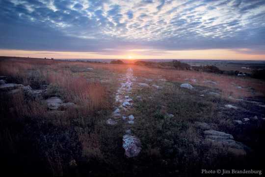 Color image of a sunrise during the autumnal equinox in Blue Mounds State Park, 1990.