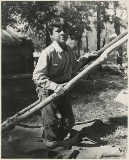 Boy treading wild rice