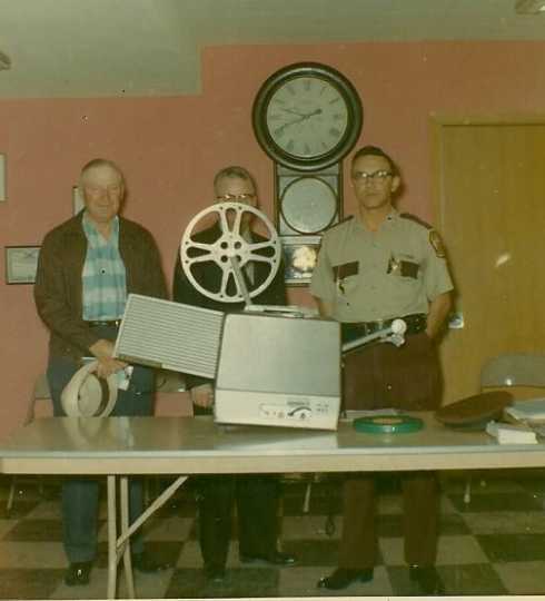 Color image of Henry Jobe and Harold Thorson at a special demonstration about slow-moving vehicle signs for farm implements and tractors, 1967.