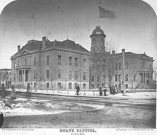 Black and white photograph of the first State Capitol building showing enlargement of 1878. Painted by Alfred Palmquist & Company, 1879.