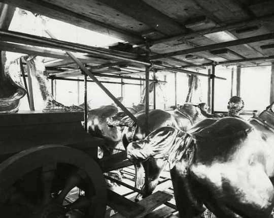 Black and white photograph of Quadriga during application of gold leaf, 1979. Photographed by Elizabeth M. Hall.