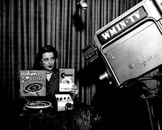 Black and white photograph of an advertisement being filmed for Stadium Checkers and a Cootie game on WMIN-TV, 1954.