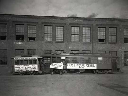 Black and white photograph of a 1872 horsecar compared to a new electric motor streetcar, May 3, 1921. Photographed by C.J. Hibbard.