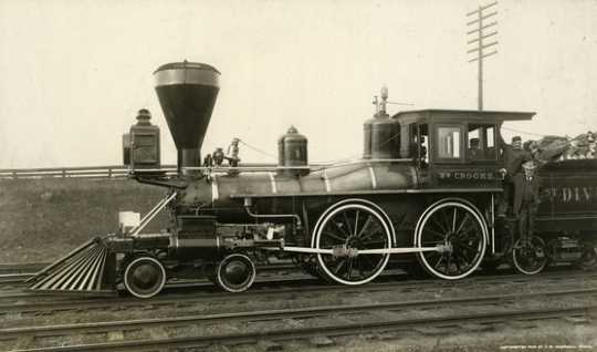 Black and white photograph of James J. Hill with two engineers on the William Crooks train engine, 1908. Photograph by T.W. Ingersoll. 