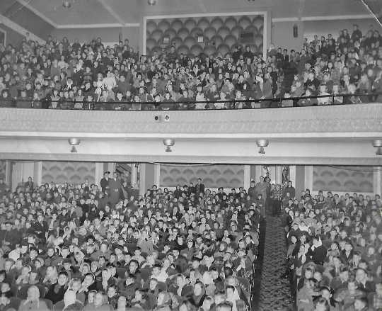 Black and white photograph of the Children at a Christmas matinee at the Grand Theater, ca. 1950s.