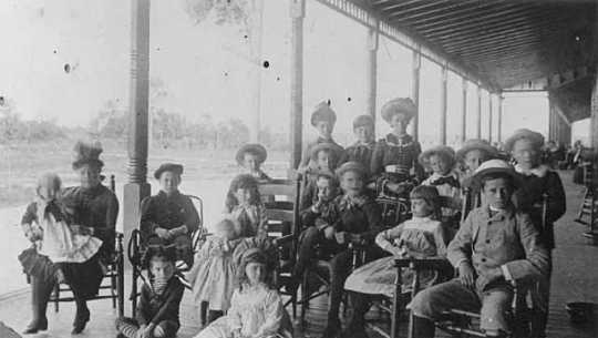 Black-and-white photograph of children on the porch of the Lafayette Hotel, c.1890.